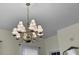 A decorative chandelier hangs from an ornate ceiling medallion, adding elegance to the interior space at 214 E Doty Ave, Summerville, SC 29483