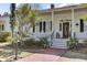 Charming white home with front porch and rocking chairs at 214 E Doty Ave, Summerville, SC 29483
