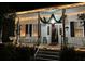 Inviting front porch adorned with festive Christmas lights and decor creating a warm, holiday welcome at 214 E Doty Ave, Summerville, SC 29483