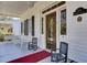 Charming front porch with rocking chairs and beautiful door at 214 E Doty Ave, Summerville, SC 29483