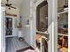 Charming front porch featuring decorative baskets, a ceiling fan, and a glimpse of the kitchen at 214 E Doty Ave, Summerville, SC 29483