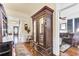 Hallway features hardwood floors, a wooden armoire, and views of the home's entry and living spaces at 214 E Doty Ave, Summerville, SC 29483