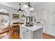 Bright and open kitchen and dining area with white cabinets, stainless appliances and large windows at 214 E Doty Ave, Summerville, SC 29483