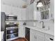 Modern kitchen with stainless steel appliances, white cabinetry, and a subway tile backsplash at 214 E Doty Ave, Summerville, SC 29483