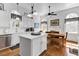 Bright kitchen with white cabinets, modern appliances, an island, and a dining area at 214 E Doty Ave, Summerville, SC 29483