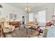 Sophisticated living room with piano, large windows, and traditional furniture and area rug at 214 E Doty Ave, Summerville, SC 29483