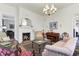 Cozy living room featuring a fireplace, piano, and antique-style furnishings at 214 E Doty Ave, Summerville, SC 29483
