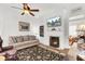 Inviting living room with a fireplace, comfortable seating, and a ceiling fan, offering a relaxing atmosphere at 214 E Doty Ave, Summerville, SC 29483