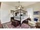 Spacious main bedroom features a four-poster bed, fireplace, and hardwood floors at 214 E Doty Ave, Summerville, SC 29483