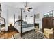 Bright main bedroom has hardwood floors, a four-poster bed, and a cozy sitting area at 214 E Doty Ave, Summerville, SC 29483