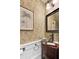 Stylish powder room featuring unique wallpaper, a glass bowl sink, and elegant fixtures at 214 E Doty Ave, Summerville, SC 29483