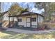 Backyard shed featuring windows, double doors, and a charming picket fence at 214 E Doty Ave, Summerville, SC 29483