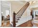 Inviting foyer showcasing a beautiful staircase with hardwood floors and traditional finishes at 214 E Doty Ave, Summerville, SC 29483