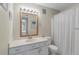 Bright bathroom with a large mirror, vanity, and shower with a white curtain at 214 Sea Cloud Cir, Edisto Island, SC 29438