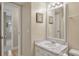 Well-lit bathroom with a marble countertop vanity and decorative framed mirror at 214 Sea Cloud Cir, Edisto Island, SC 29438