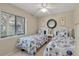 Inviting bedroom with twin beds featuring seashell bedding and a natural light window at 214 Sea Cloud Cir, Edisto Island, SC 29438