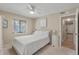 Comfortable bedroom with plush bedding, ceiling fan, and natural light from the window at 214 Sea Cloud Cir, Edisto Island, SC 29438