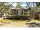 Charming condo building with multiple levels, surrounded by lush trees and manicured shrubbery at 214 Sea Cloud Cir, Edisto Island, SC 29438