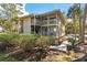 Inviting condo exterior showcasing a private deck nestled among lush greenery and mature trees at 214 Sea Cloud Cir, Edisto Island, SC 29438