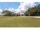Expansive view of a golf course, showcasing a house with a flagpole in the distance at 214 Sea Cloud Cir, Edisto Island, SC 29438