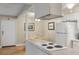 Well-lit kitchen with a cooktop and breakfast bar overlooking the dining area and living room at 214 Sea Cloud Cir, Edisto Island, SC 29438