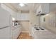 Practical kitchen with white cabinets and appliances, including a microwave, refrigerator, and electric stovetop at 214 Sea Cloud Cir, Edisto Island, SC 29438