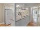 Bright kitchen with white cabinetry, modern appliances, and hardwood floors leading to a hallway at 214 Sea Cloud Cir, Edisto Island, SC 29438