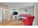 Comfortable living room with a bright striped sofa, hardwood flooring, and stylish wall decor at 214 Sea Cloud Cir, Edisto Island, SC 29438