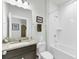 Bathroom features a vanity with granite countertop and tiled tub-shower combo at 220 Garden Gate Way, Summerville, SC 29486