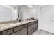Bright bathroom features a double vanity with granite countertop and modern fixtures, along with white cabinets and a large mirror at 220 Garden Gate Way, Summerville, SC 29486