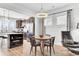 Bright dining area with wood floors, a modern light fixture, and seating for four at 220 Garden Gate Way, Summerville, SC 29486