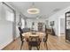Open dining space with wood floors, a round table, and a view into the living room at 220 Garden Gate Way, Summerville, SC 29486
