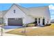 Charming single-story home featuring a two-car garage, and a beautifully landscaped front yard at 220 Garden Gate Way, Summerville, SC 29486