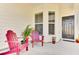 Inviting front porch area with colorful chairs, plants, and stylish front door at 220 Garden Gate Way, Summerville, SC 29486