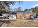 A single story home with brick exterior, covered patio, and fenced backyard at 2236 Pinehurst Ave, Charleston, SC 29414
