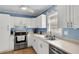 Bright kitchen with stainless steel appliances, white cabinets, and ample counter space at 2236 Pinehurst Ave, Charleston, SC 29414