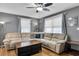 Cozy living room featuring a large comfortable sofa, hardwood floors, and natural lighting at 2236 Pinehurst Ave, Charleston, SC 29414
