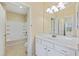 Bathroom featuring a white vanity with an adjacent room with a tub and shower at 2244 Ashley Crossing Dr # 1236, Charleston, SC 29414