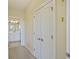 Hallway with carpet and linen closet and an open view of the bathroom featuring white vanity at 2244 Ashley Crossing Dr # 1236, Charleston, SC 29414