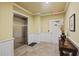Hallway with elevator, stairs, tile flooring, and decorative table and accessories at 2244 Ashley Crossing Dr # 1236, Charleston, SC 29414