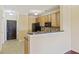 Kitchen featuring wood cabinets, black appliances, and a breakfast bar with tile flooring at 2244 Ashley Crossing Dr # 1236, Charleston, SC 29414