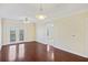Bright living room with hardwood floors, ceiling fan, and access to a balcony with natural light at 2244 Ashley Crossing Dr # 1236, Charleston, SC 29414