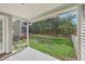 Covered back patio with a small glass table and well-maintained backyard grass and landscaping at 234 Darcy Ave, Goose Creek, SC 29445