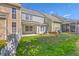 Backyard view with partial fence line, covered patio, grass lawn and view of multi-level condo units at 234 Darcy Ave, Goose Creek, SC 29445
