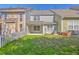 Backyard view with partial fence line, covered patio, grass lawn and view of multi-level condo units at 234 Darcy Ave, Goose Creek, SC 29445