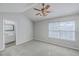 Carpeted bedroom featuring neutral walls, a ceiling fan, and a window bringing in natural light, complemented by an ensuite at 234 Darcy Ave, Goose Creek, SC 29445