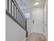 Bright foyer showcasing hardwood floors, staircase, and convenient coat closet at 234 Darcy Ave, Goose Creek, SC 29445