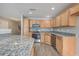 Well-lit kitchen with wood cabinets, stainless steel appliances, and granite countertops at 234 Darcy Ave, Goose Creek, SC 29445