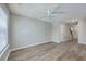 Spacious living room with modern ceiling fan, light gray walls, and wood floor at 234 Darcy Ave, Goose Creek, SC 29445