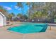 Enjoy this inviting community pool surrounded by lush greenery and palm trees on a sunny day at 234 Darcy Ave, Goose Creek, SC 29445